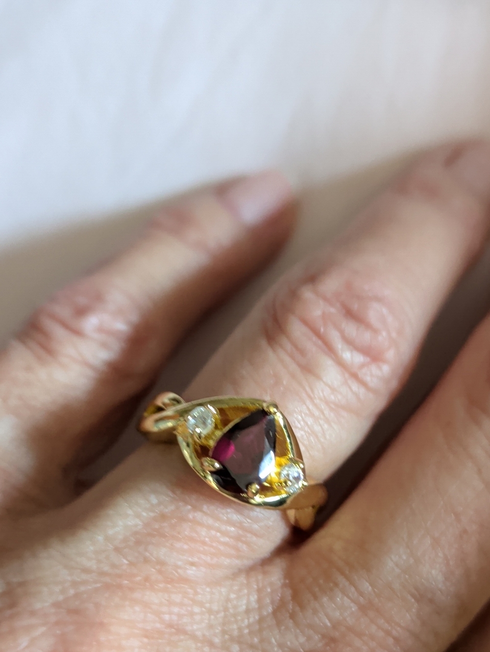 Gold-Tone Ring with Deep Red Pearl Shaped Center Stone and Accent Gems